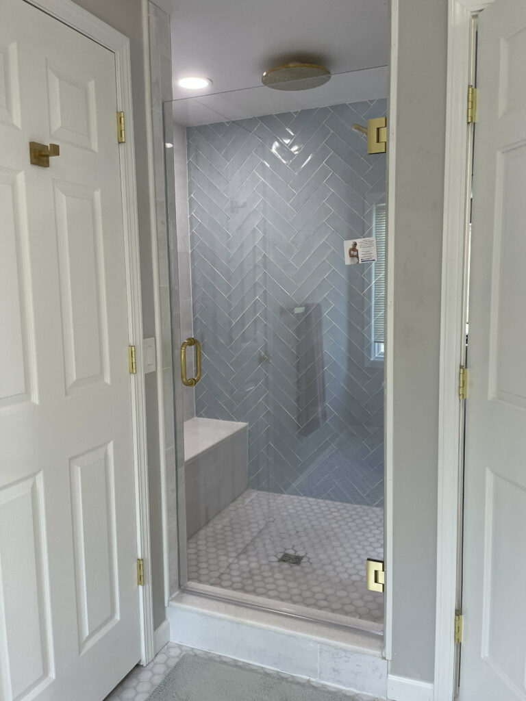 Frameless glass shower door installed by professionals.